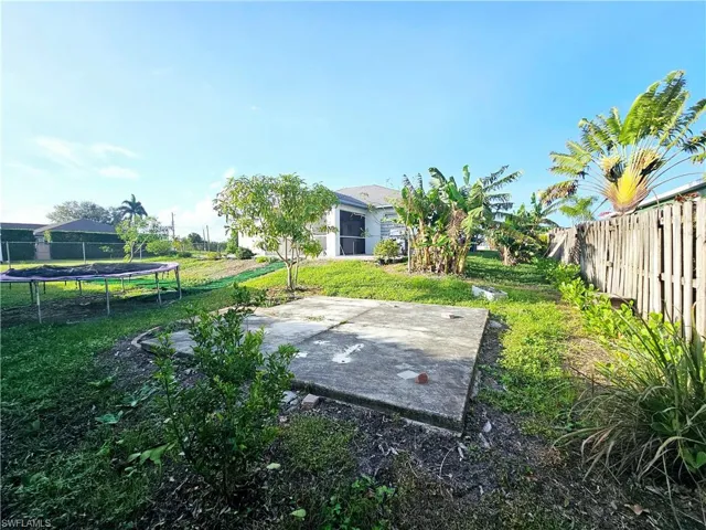 View of yard featuring a patio and a trampoline