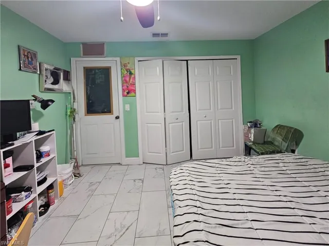 Bedroom featuring ceiling fan and a closet
