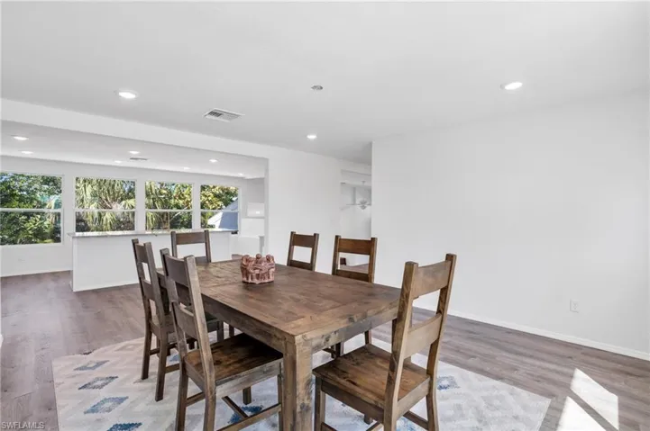 Virtual Staged- Dining room with light wood-type flooring - VIRTUALLY ENHANCED