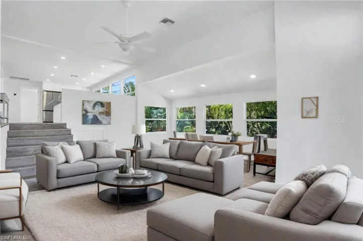 Virtual Staged- Living room featuring ceiling fan and high vaulted ceiling - VIRTUALLY ENHANCED