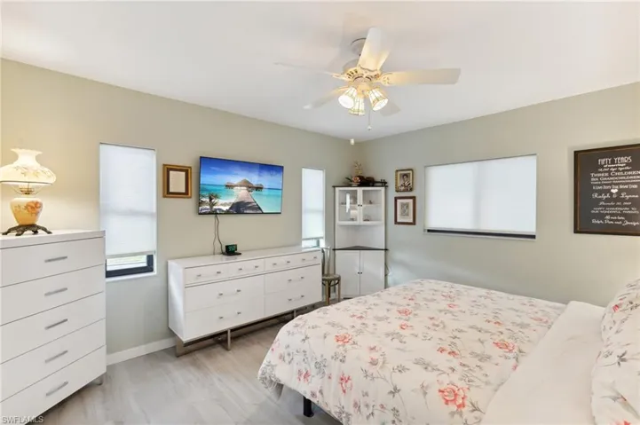 Bedroom with ceiling fan and light hardwood / wood-style flooring