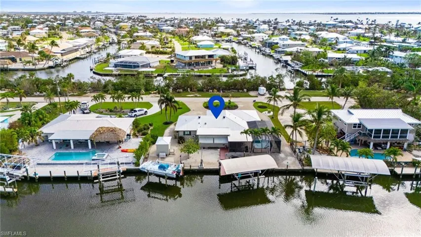Birds eye view of property with a water view