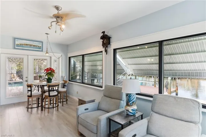 Living room with french doors, light hardwood / wood-style flooring, and ceiling fan