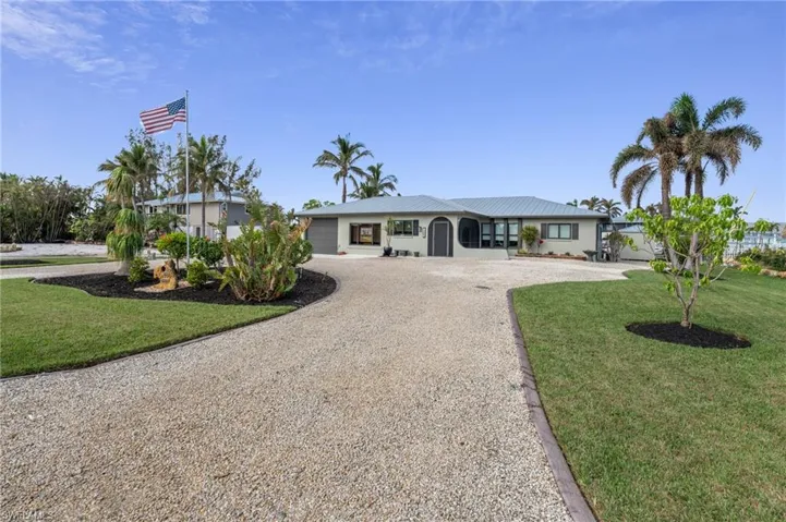 Ranch-style house featuring a front yard and a garage