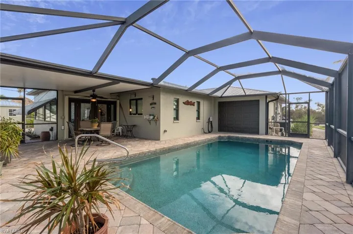 View of pool featuring a lanai, ceiling fan, and a patio