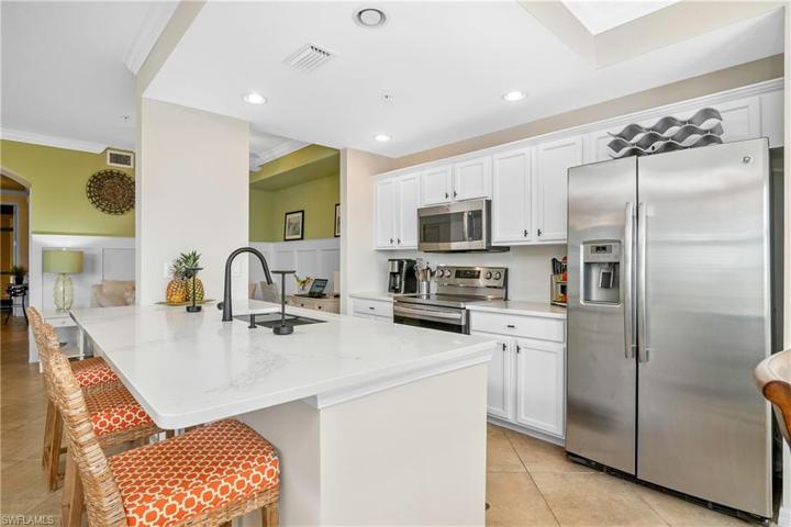Updated kitchen with white cabinets and new/lowered/extended quartz counter