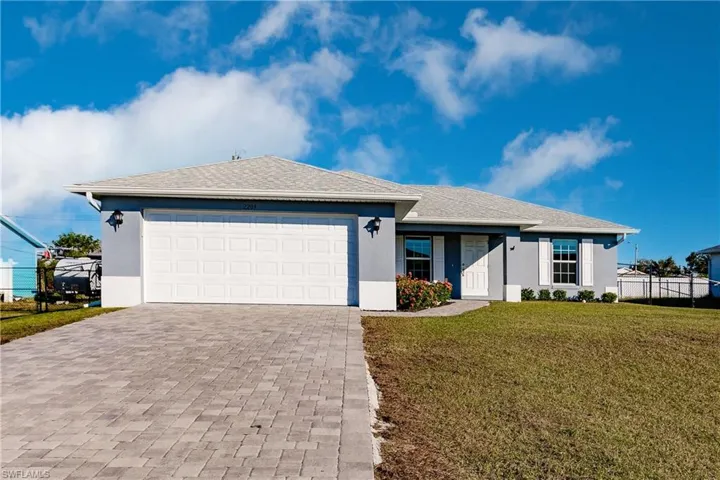 Single story home with a front yard and a garage