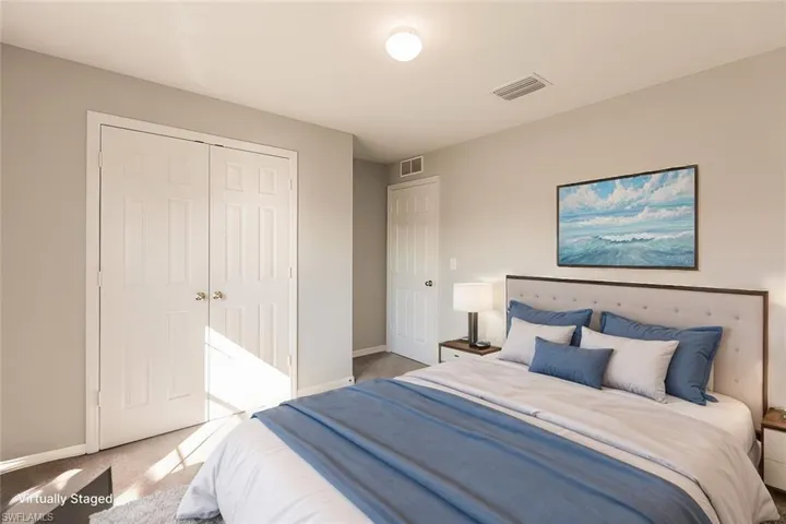 Carpeted bedroom featuring a closet