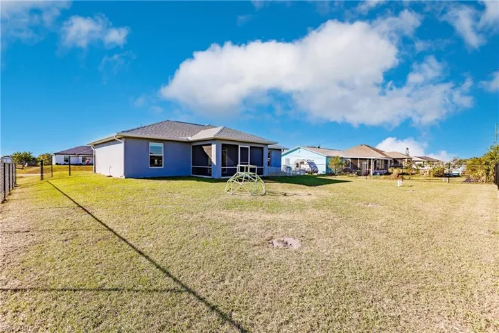 Back of property with a yard and a sunroom