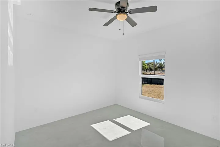 Unfurnished room featuring a ceiling fan