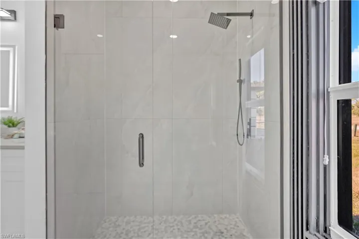 Full bath featuring a shower stall