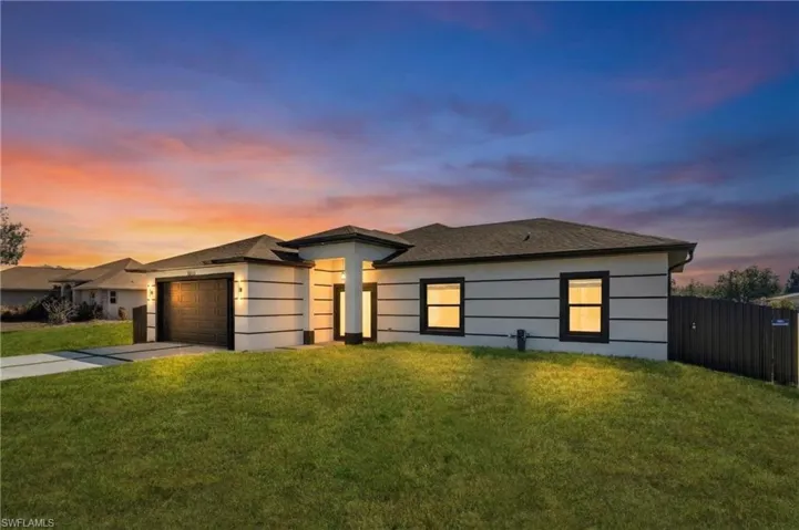 Prairie-style home featuring concrete driveway, a garage, and a shingled roof