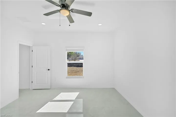 Empty room with recessed lighting and a ceiling fan
