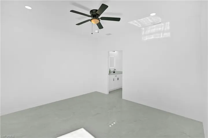 Spare room with concrete floors, ceiling fan, and recessed lighting