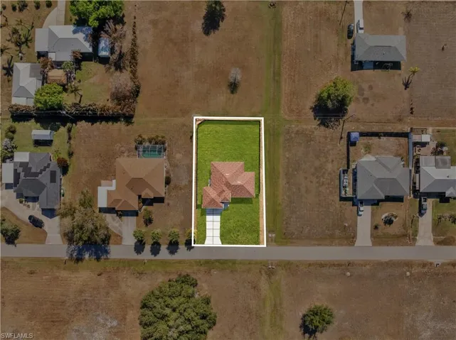 Aerial view of residential area with property parcel outlined