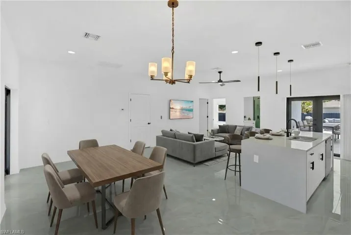Dining area featuring a chandelier, ceiling fan, and recessed lighting
