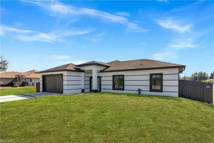 Prairie-style house with driveway, an attached garage, and a shingled roof