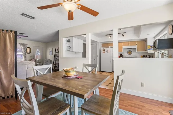Dining area with a ceiling fan and a textured ceiling