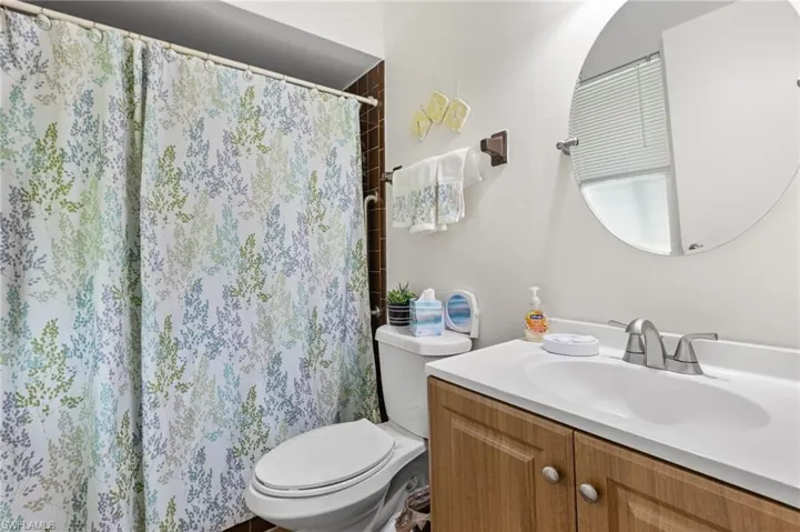 Full bathroom featuring vanity and curtained shower
