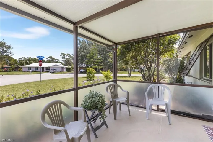 Sunroom / solarium with finished concrete flooring, beam ceiling, and plenty of natural light