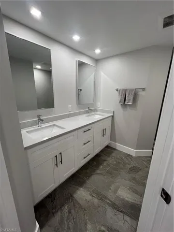 Features bidet with heated seat, shaker vanity with quartzite, & shower