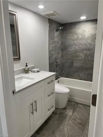 Features bidet with heated seat, shaker vanity with quartzite, bath tub & shower