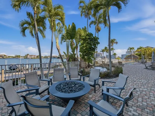 View of patio featuring an outdoor fire pit and a water view