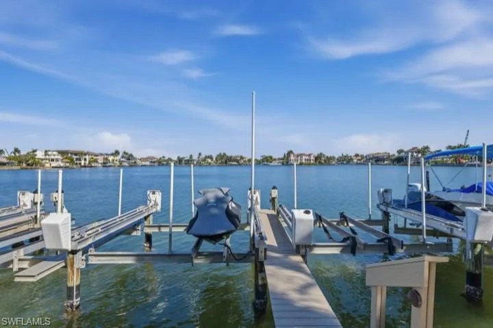Dock with boat lift and a water view