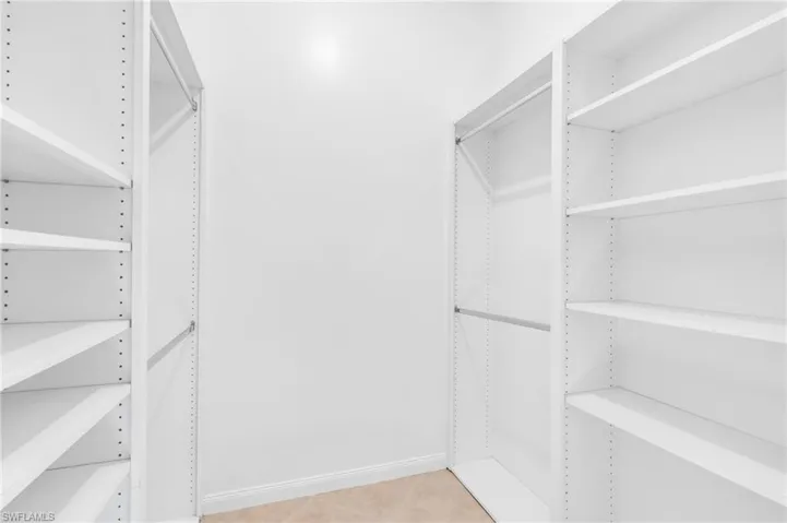Spacious closet with light tile patterned floors