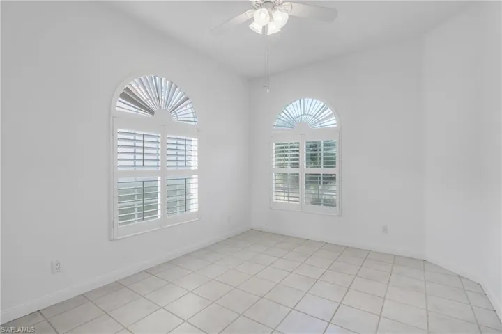 Spare room featuring ceiling fan and light tile patterned flooring