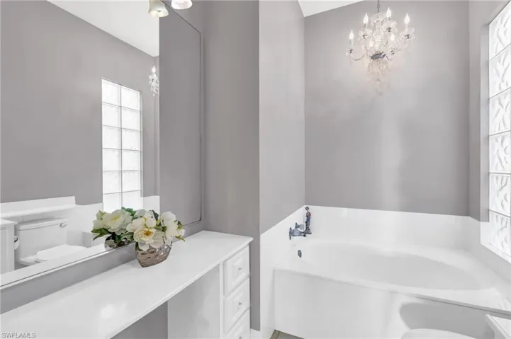Bathroom with vanity, toilet, and a washtub