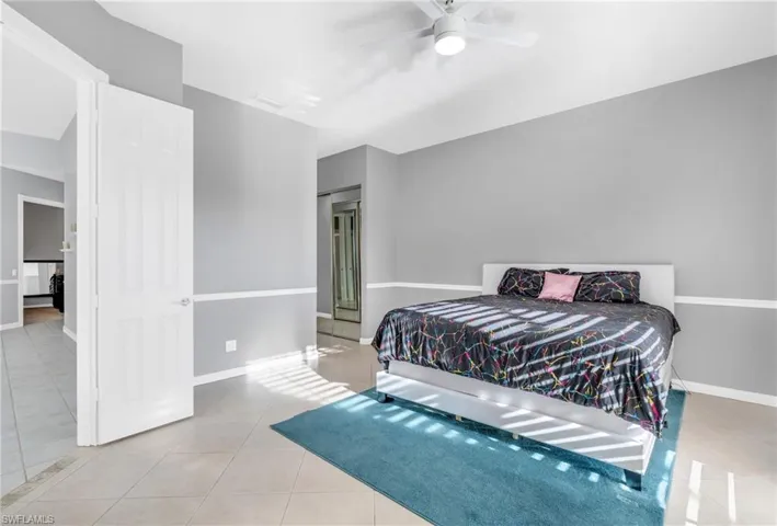 Bedroom featuring ceiling fan and light tile patterned flooring