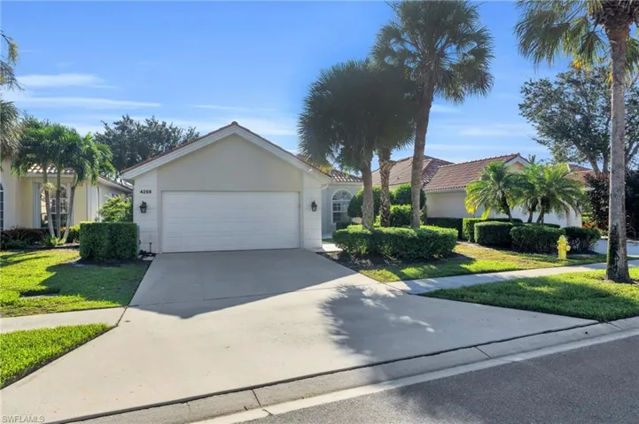 View of front of home featuring a front yard and a garage