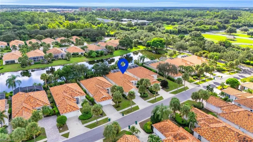 Birds eye view of property with a water view