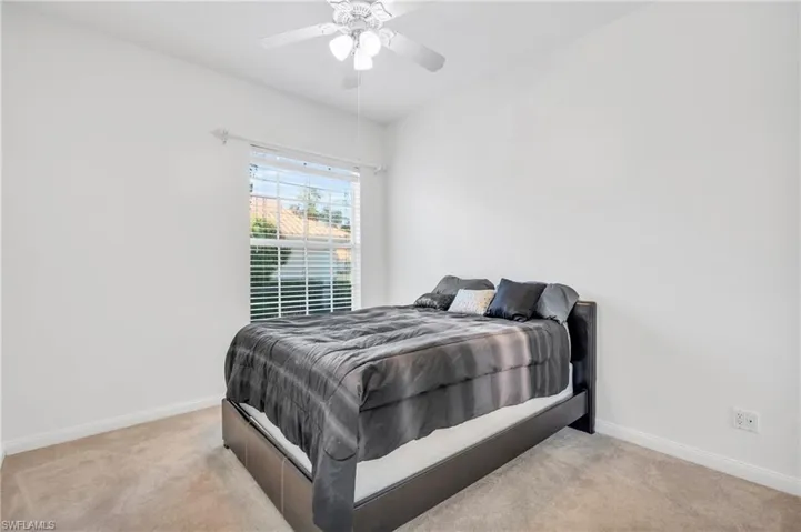 Carpeted bedroom with ceiling fan