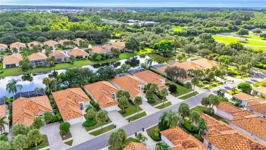 Birds eye view of property with a water view