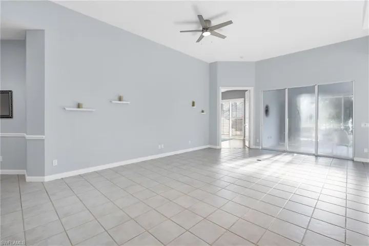 Spare room with ceiling fan and light tile patterned flooring