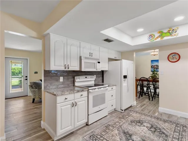 Kitchen toward entry and living room, dining area