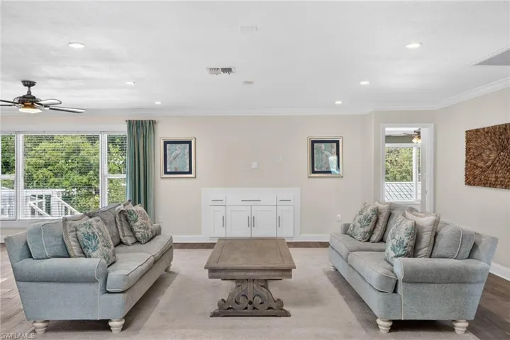living room with furnture showcasing TV wall with storage underneath