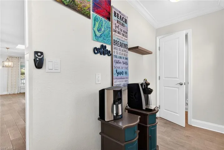 Behind the kitchen is a hallway that leads to a half bath and the deck outside in the back yard.