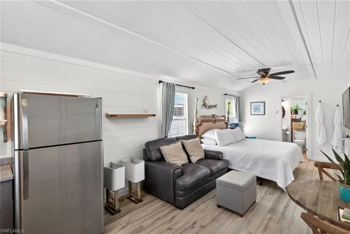 Cottage features vinyl floors, shiplap walls, and window coverings