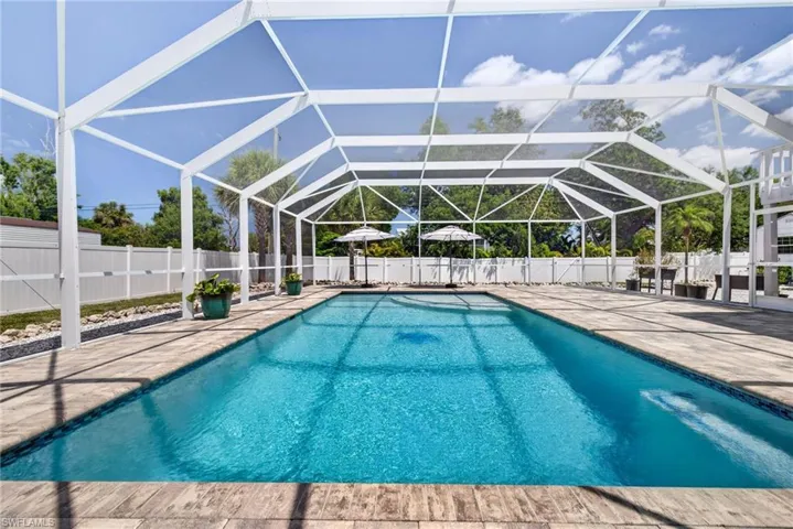Entire backyard is fenced for privacy and security.  Custom pool is 7' deep with a sunshelf and integrated seat.