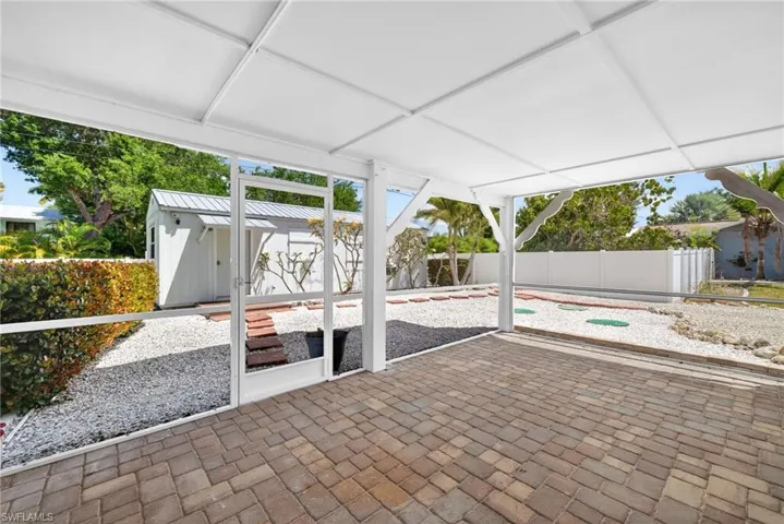 Covered screened patio with paver flooring could be for use of the main house or cottage