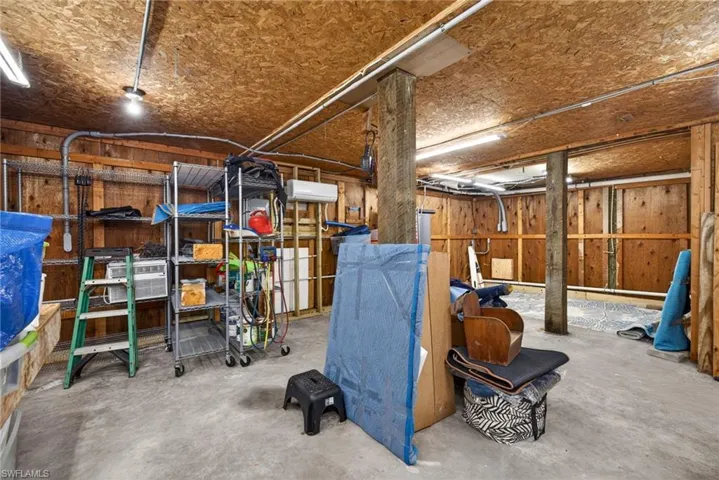 Garage has a separate storage room with built in workbenches and a separate split system AC