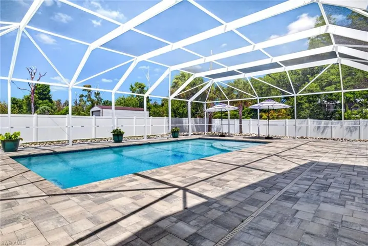 Huge screened pool deck and pool are great for entertaining or catching some sun.