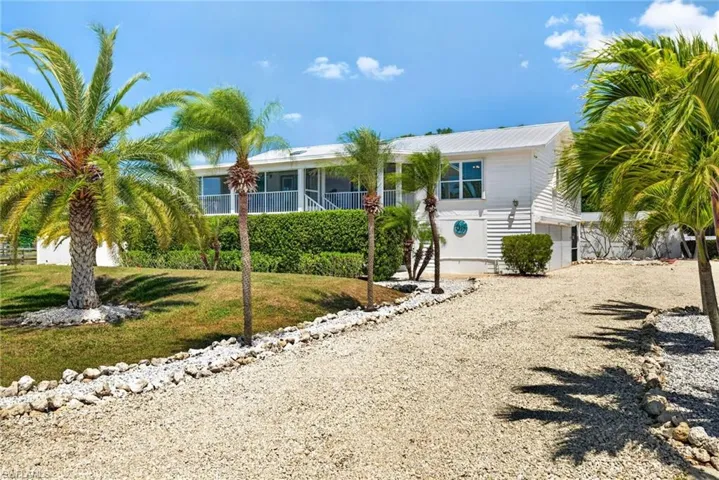 Elevated main home with tons of parking space and mature landscaping
