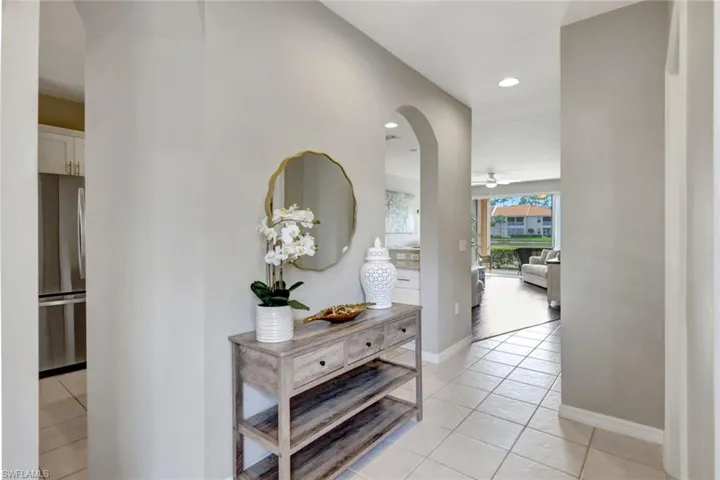 Foyer corridor featuring neutral tile floors