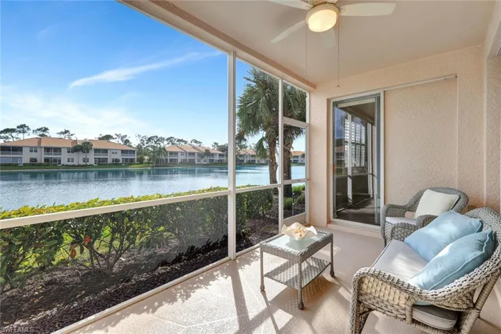 Sunroom / solarium with wide water views and ceiling fan. Disappearing sliding door leads to primary bedroom.
