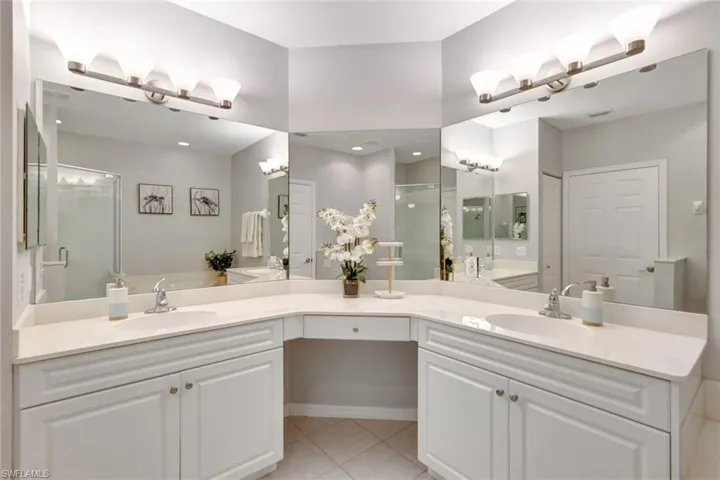 Bathroom with sitting vanity, modern light fixtures, jacuzzi size tub plus walk in shower!