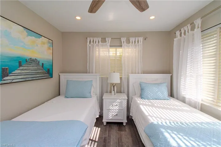 Bedroom featuring ceiling fan and dark wood-type flooring